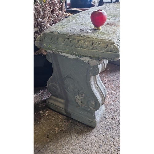 857 - Reconstituted stone garden bench with classical detailing, features ornate scrolled legs and a textu... 