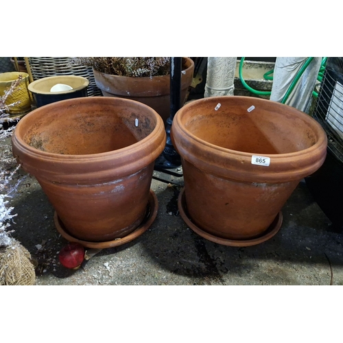 865 - Pair of large terracotta plant pots with matching saucers. Classic design with drainage holes.