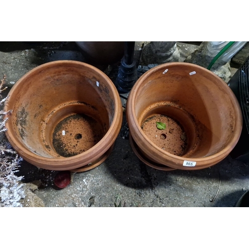 865 - Pair of large terracotta plant pots with matching saucers. Classic design with drainage holes.