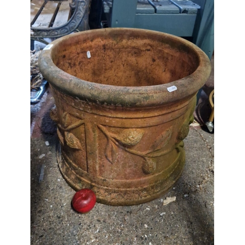 866 - A very Large decorative terracotta planter with raised leaf motif. Approximately 18 inches in diamet... 