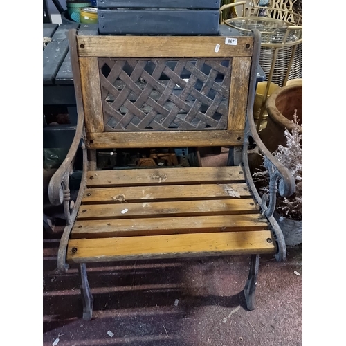 867 - Pair of vintage wooden garden benches with ornate cast iron armrests and lattice back design. heavy ... 