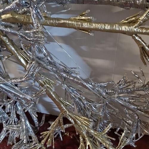 876 - Silver and gold decorative snowflake, metallic wire construction, featuring integrated lights.