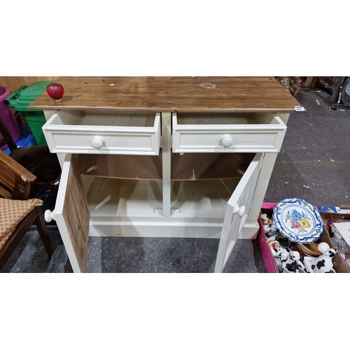 882 - Star lot :Wooden sideboard with natural top and painted cream base, featuring two drawers and two ca... 