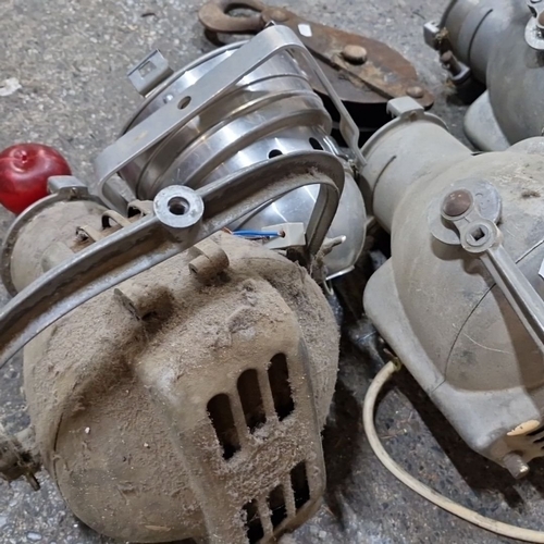 884 - Set of four vintage strand electric  industrial spotlights  plus one other and a metal pulley.