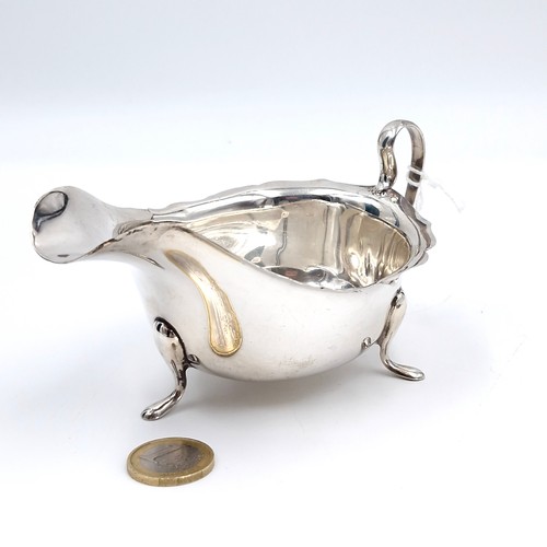 612 - A sterling silver gravy boat standing on three paw feet hallmarked Sheffield - 1940. Maker - Edward ... 