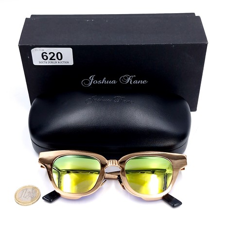 620 - A pair of Joshua Kane sunglasses with gilt metal frames. Presented in original case & box.