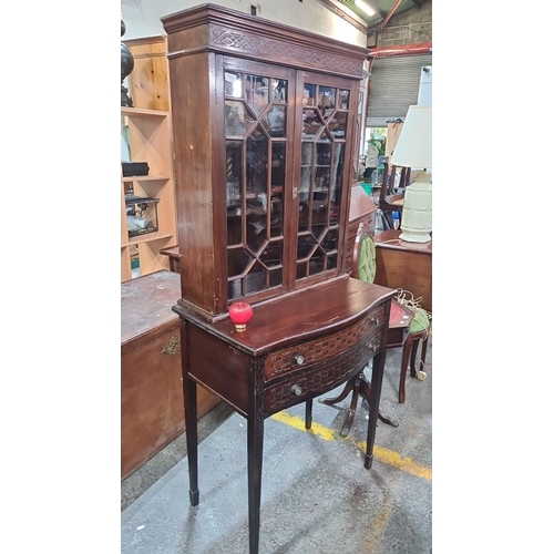 705 - Star Lot : Edwardian mahogany display cabinet with glazed doors and two intricately carved drawers.