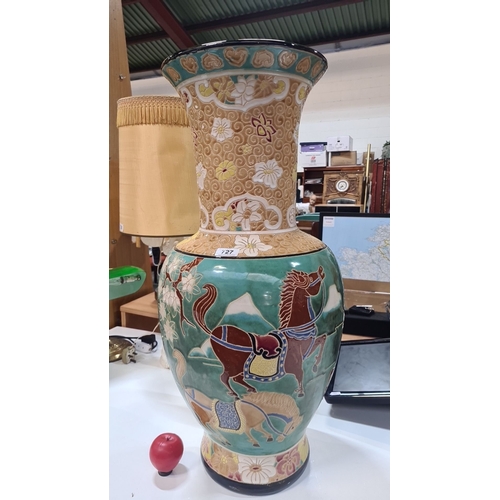 727 - Star Lot : A very Colorful large ceramic vase featuring floral patterns and horses, with intricate d... 