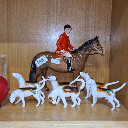 745 - Star Lot : Beswick porcelain figurine set featuring a huntsman on horseback with five hounds, marked... 