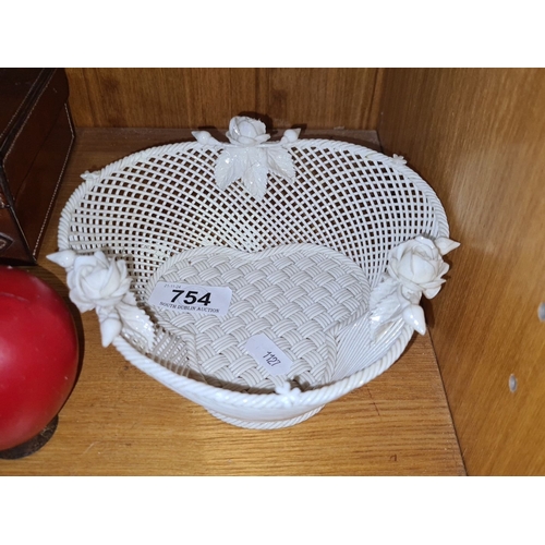 754 - Star Lot : An Irish early belleek porcelain basket with intricate lattice design and floral accents.... 