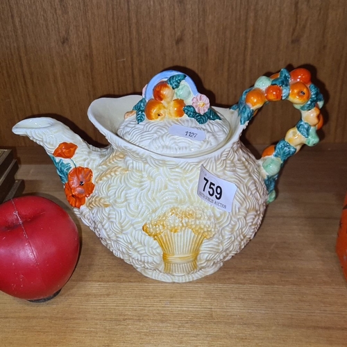 759 - Vintage Newport Pottery Co. teapot, England. Features a floral and fruit motif with an embossed text... 