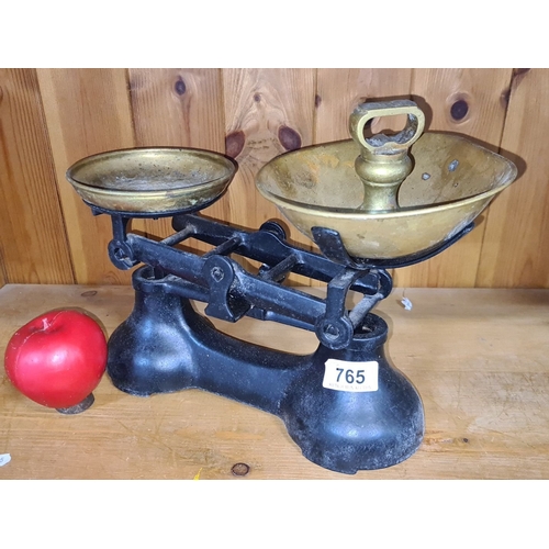 765 - Antique cast iron and brass balance scale from the early 20th century, featuring classic design with... 