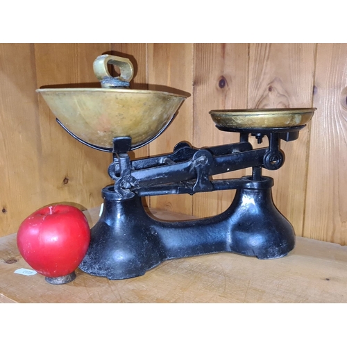 765 - Antique cast iron and brass balance scale from the early 20th century, featuring classic design with... 