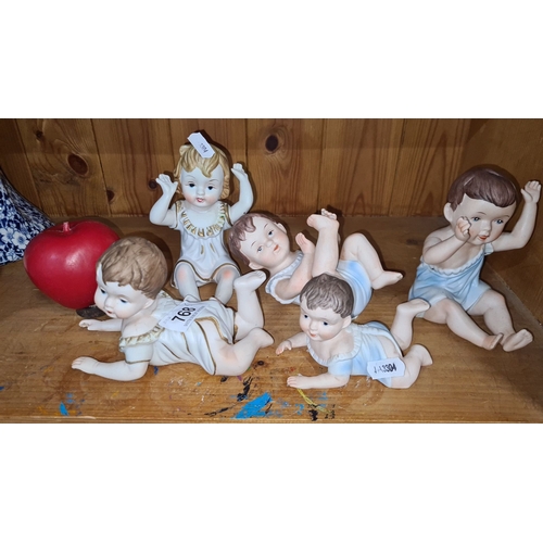 768 - Five antique German Bisque figurines of children, marked with a crowned 'A', from the 20th century.