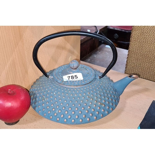 785 - A heavy Blue cast iron Japanese teapot with textured pattern and black handle, featuring a ribbed bo... 