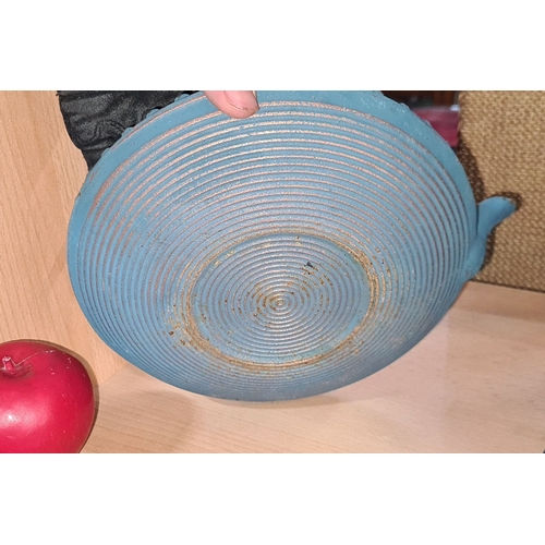 785 - A heavy Blue cast iron Japanese teapot with textured pattern and black handle, featuring a ribbed bo... 