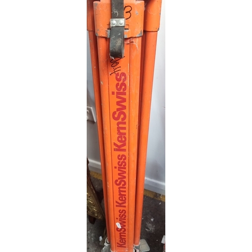 825 - Pair of orange Kern Swiss surveyor tripods, featuring robust design and adjustable legs.