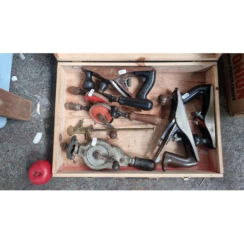 830 - Wooden box includes 2 hand drills and 3 wood planes. Box features 