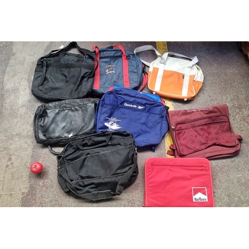 832 - Collection of eight vintage sports and travel bags, featuring Reebok and Marlboro branding, includin... 