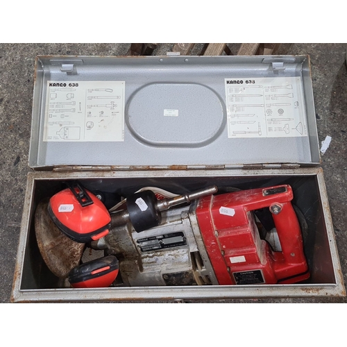 A Kango 638 hammer drill in original metal box, includes assorted tools and attachments. It features iconic industrial design with visible brand markings.