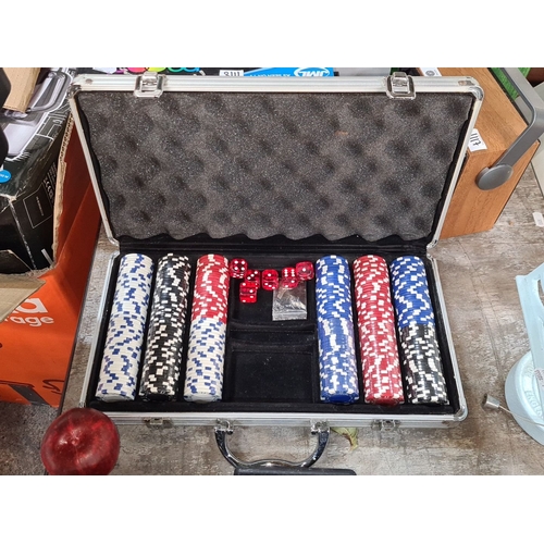 1116 - A Poker chip set in an aluminum case, featuring multicolored chips and dice.