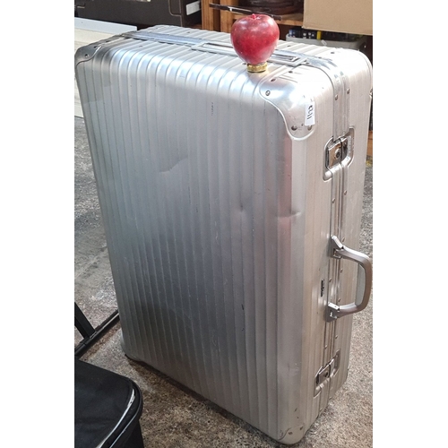 1127 - A Rimowa Aluminum Topas suitcase features a ribbed design, dual handles, and an integrated lock syst... 