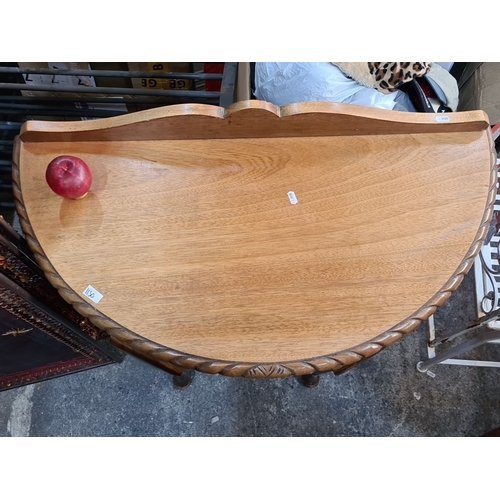 1130 - An Oak demilune console table with carved edge detail and cabriole legs.