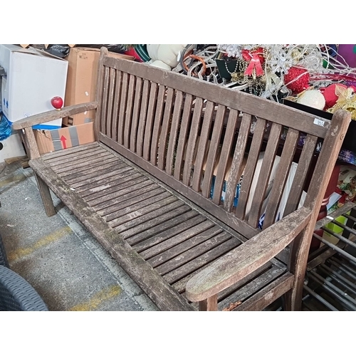 1133 - Wooden garden bench with slatted back and seat, featuring curved armrests. Classic outdoor furniture... 