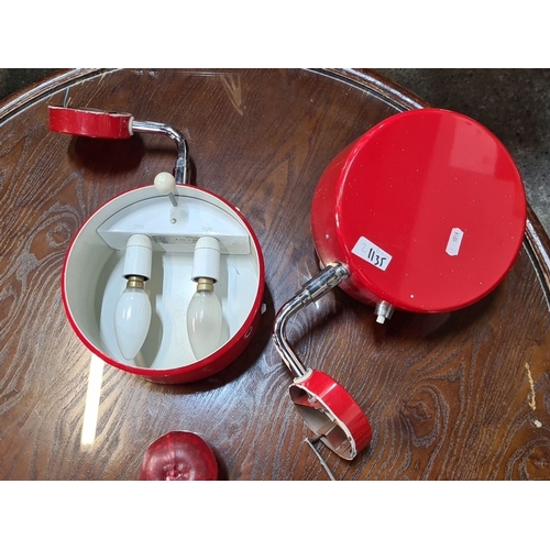 1135 - Pair of vintage red metal wall sconces with adjustable chrome arms and dual bulb holders. Mid-centur... 