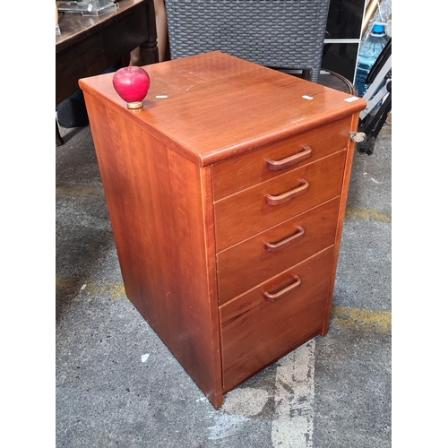 1139 - Mid-Century Modern wooden filing cabinet with four drawers, featuring sleek handles.