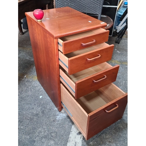 1139 - Mid-Century Modern wooden filing cabinet with four drawers, featuring sleek handles.