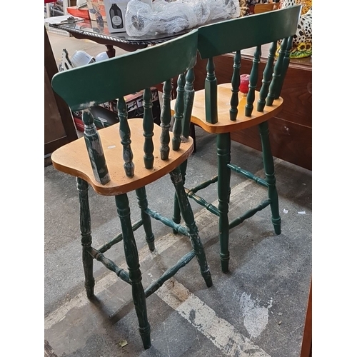 1140 - Pair of rustic green wooden bar stools with curved backrests and spindle details.