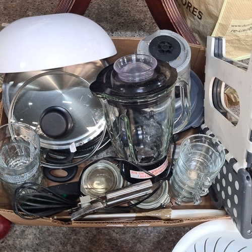 1142 - A box containing kitchen utensils including a blender, a whisk and a strainer.