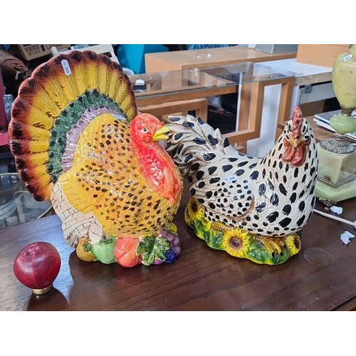 1147 - Two Colorful ceramic turkey and hen figurines, hand-painted with vibrant detailing. Ornamental piece... 