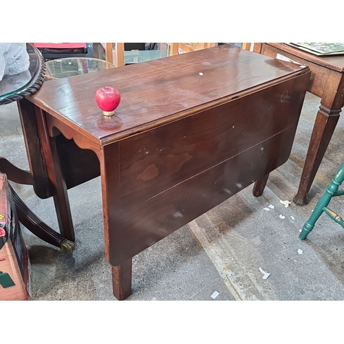 1149 - Mahogany drop-leaf dining table, featuring elegant scalloped apron details, from the Mid-Century Mod... 