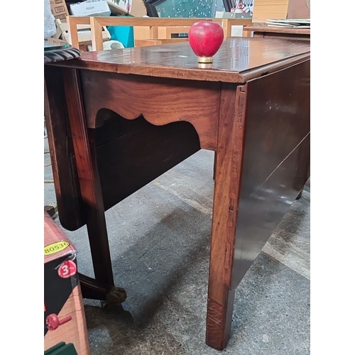 1149 - Mahogany drop-leaf dining table, featuring elegant scalloped apron details, from the Mid-Century Mod... 