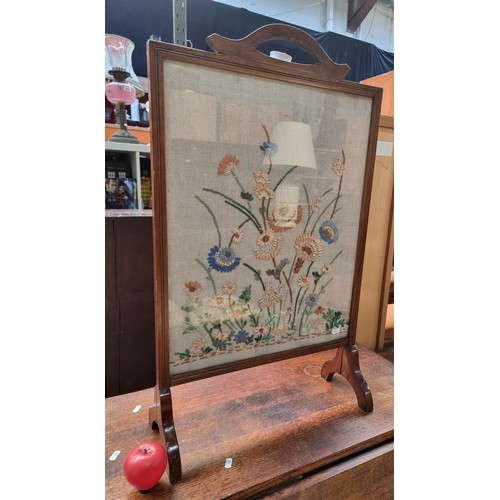 827 - Antique wood-framed firescreen featuring a hand-embroidered floral design on fabric. From the early ... 