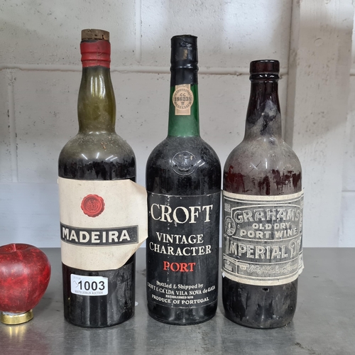 1003 - Three bottles of alcohol including a Croft Vintage Character Port, a vintage bottle of Madeira wine ... 