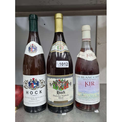 1012 - Three sealed bottles of alcohol including a 75cl bottle of Hock German table wine, a 75cl bottle of ... 