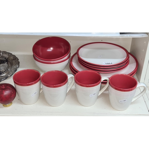 1064 - 13 pieces of Denby including cups, bowls, side plates and dinner plates. All in good condition.