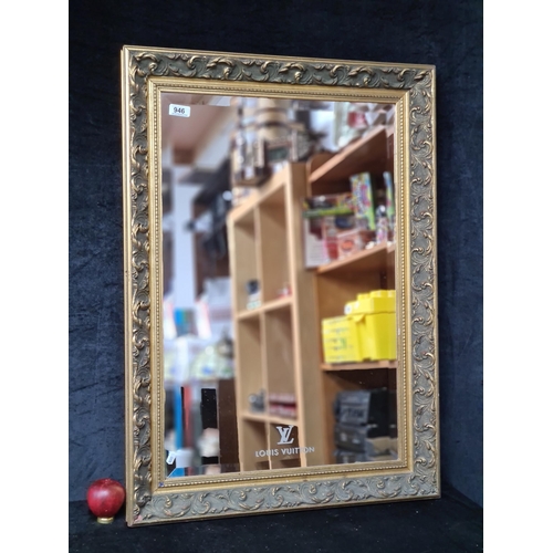 946 - A fabulous heavy wall hanging Louis Vuitton mirror. Complete in an ornate gilt frame and the iconic ... 