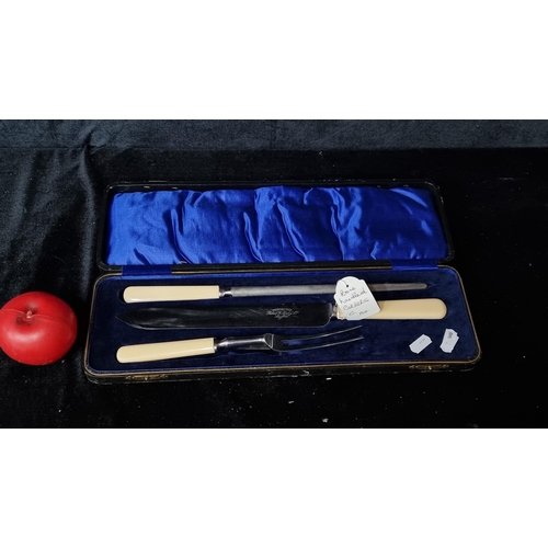 965 - A beautiful bone handled carver set, circa 1910 and stamped Rusnorstain. Housed in original leather ... 