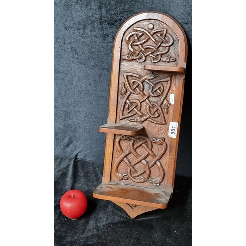 981 - A beautiful antique walnut wall mounted shelving unit showcasing unique Celtic design in high relief... 