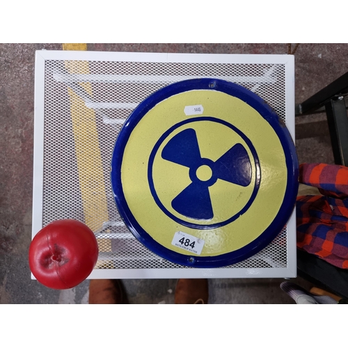 484 - An original vintage  circular thick enamel Radioactive wall sign.