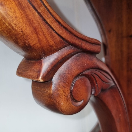 1243 - A very handsome Victorian mahogany console table with intricately carved scroll legs and a shaped to... 