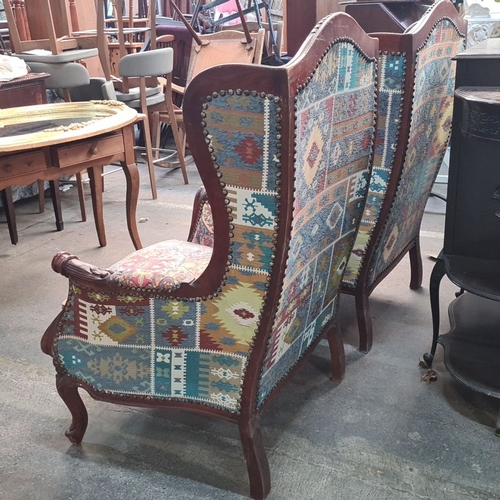 1244 - Star Lot : A fabulous Pair of carved wingback armchairs with carved wood frames and vibrant tapestry... 