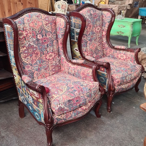 1244 - Star Lot : A fabulous Pair of carved wingback armchairs with carved wood frames and vibrant tapestry... 