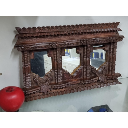 1258 - A hand carved Nepalese wooden carving of Temple windows with mirrored back. Has a tramp art look abo... 