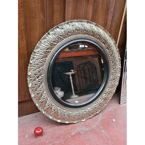 1355 - Round decorative mirror featuring a leaf-patterned frame, branded West Decor.
Previous in auction on... 