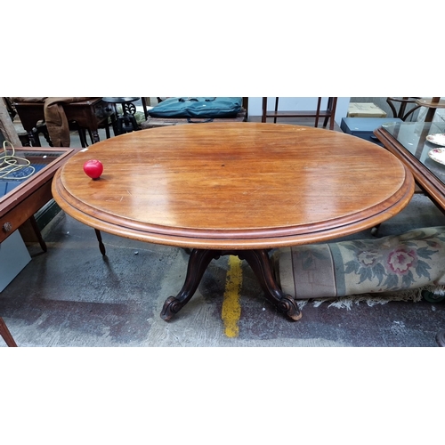 1360 - Star lot : A fabulous round Gold Mahogany dining table with a carved pedestal base, showcasing a ric... 